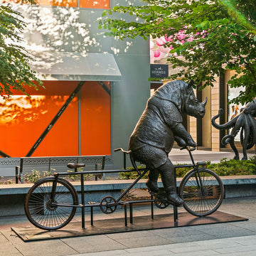 The Javan Rhino Races on the Bicycle (Bronze Sculpture)