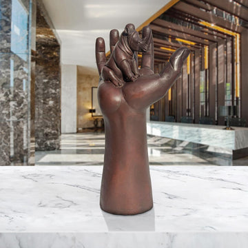 A Rhino up High in a Hand (Bronze Sculpture)