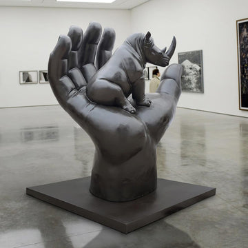 A Rhino in a Big Hand (Bronze Sculpture)