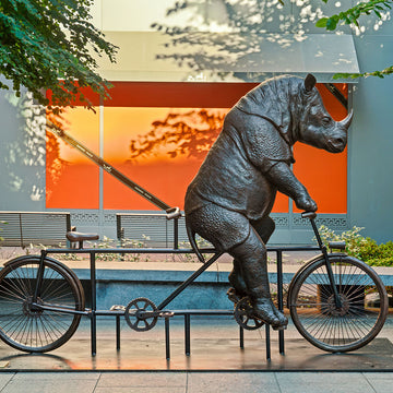 The Javan Rhino Races on the Bicycle (Bronze Sculpture)