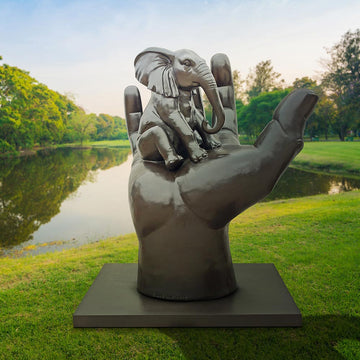 An Elephant in a Big Hand (Bronze Sculpture)