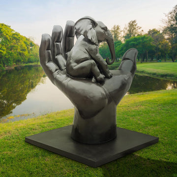 An Elephant in a Big Hand (Bronze Sculpture)