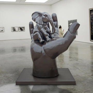 An Elephant in a Big Hand (Bronze Sculpture)