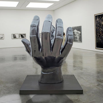 An Elephant in a Big Hand (Bronze Sculpture)