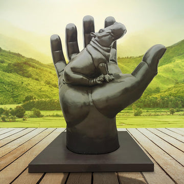 A Hippo in a Big Hand (Bronze Sculpture)