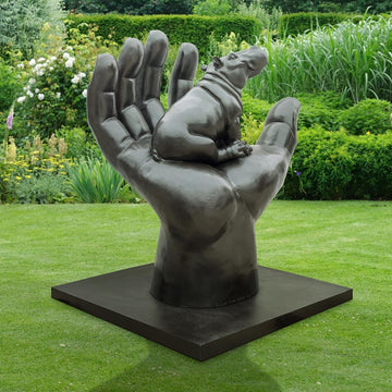 A Hippo in a Big Hand (Bronze Sculpture)