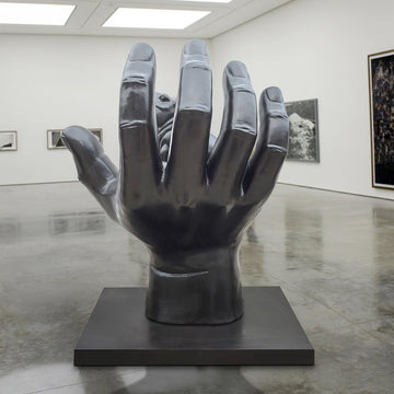 A Hippo in a Big Hand (Bronze Sculpture)