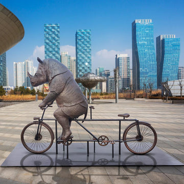 The Javan Rhino Races on the Bicycle (Bronze Sculpture)