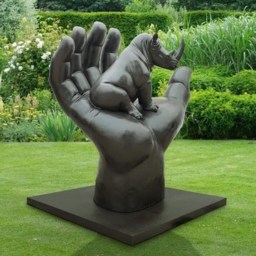 A Rhino in a Big Hand (Bronze Sculpture)