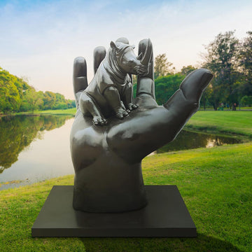 A Rhino in a Big Hand (Bronze Sculpture)