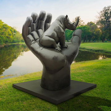 A Rhino in a Big Hand (Bronze Sculpture)