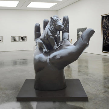 A Rhino in a Big Hand (Bronze Sculpture)